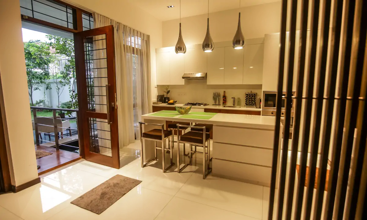 Kitchen and breakfast counter, with glazed timber doors open to the garden