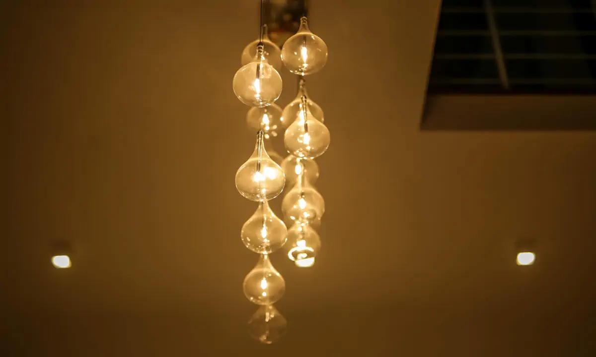 Cluster of glass globe pendants hanging in a double-height void