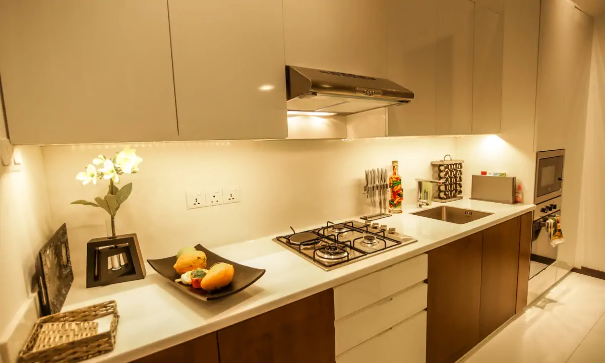 Kitchen worktop with a gas hob and white and timber cabinets