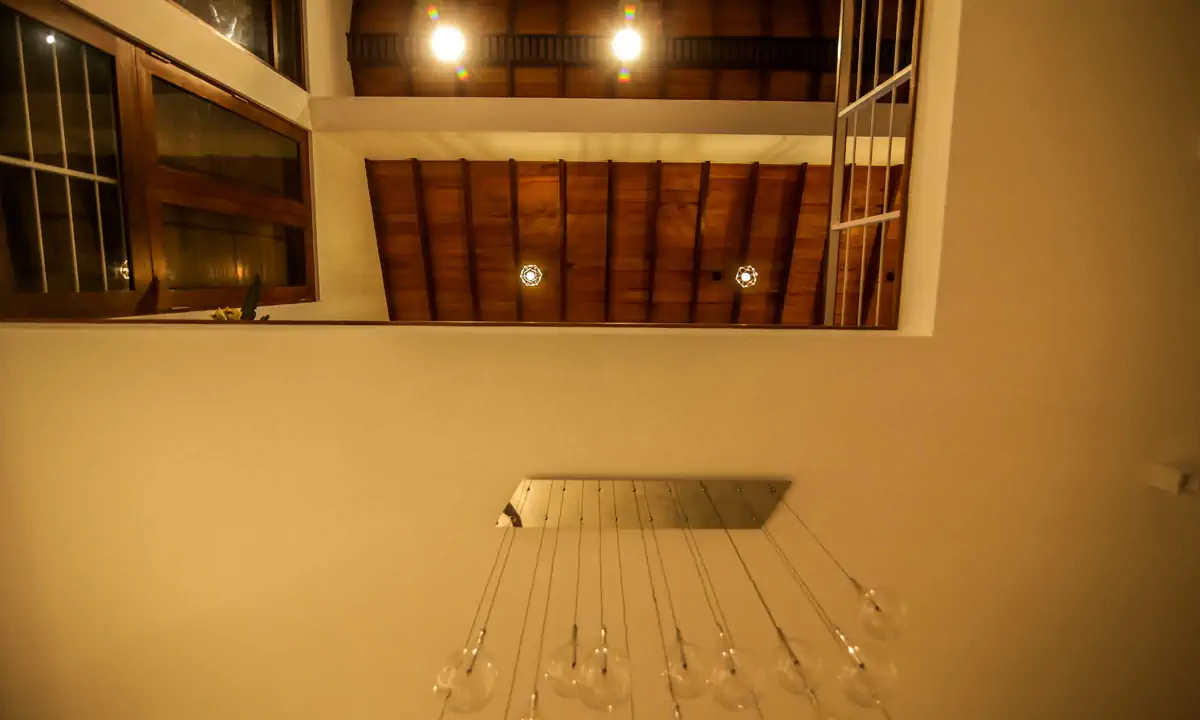 Looking up through the double-height void to the timber-lined ceiling