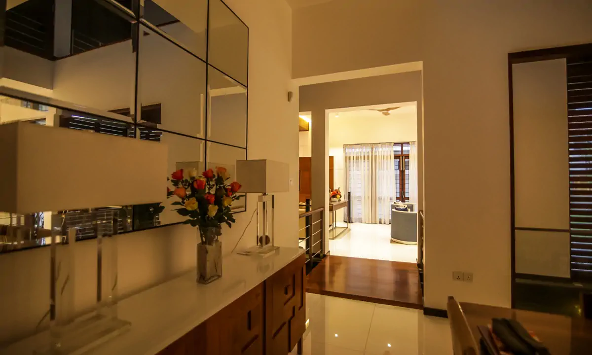 Upstairs landing with a timber sideboard, looking through to a bedroom