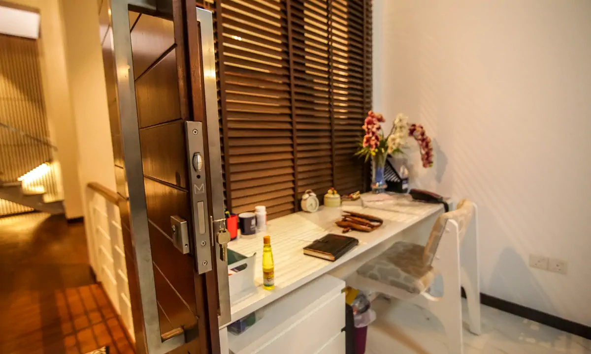 Study desk beside a timber door and timber blinds