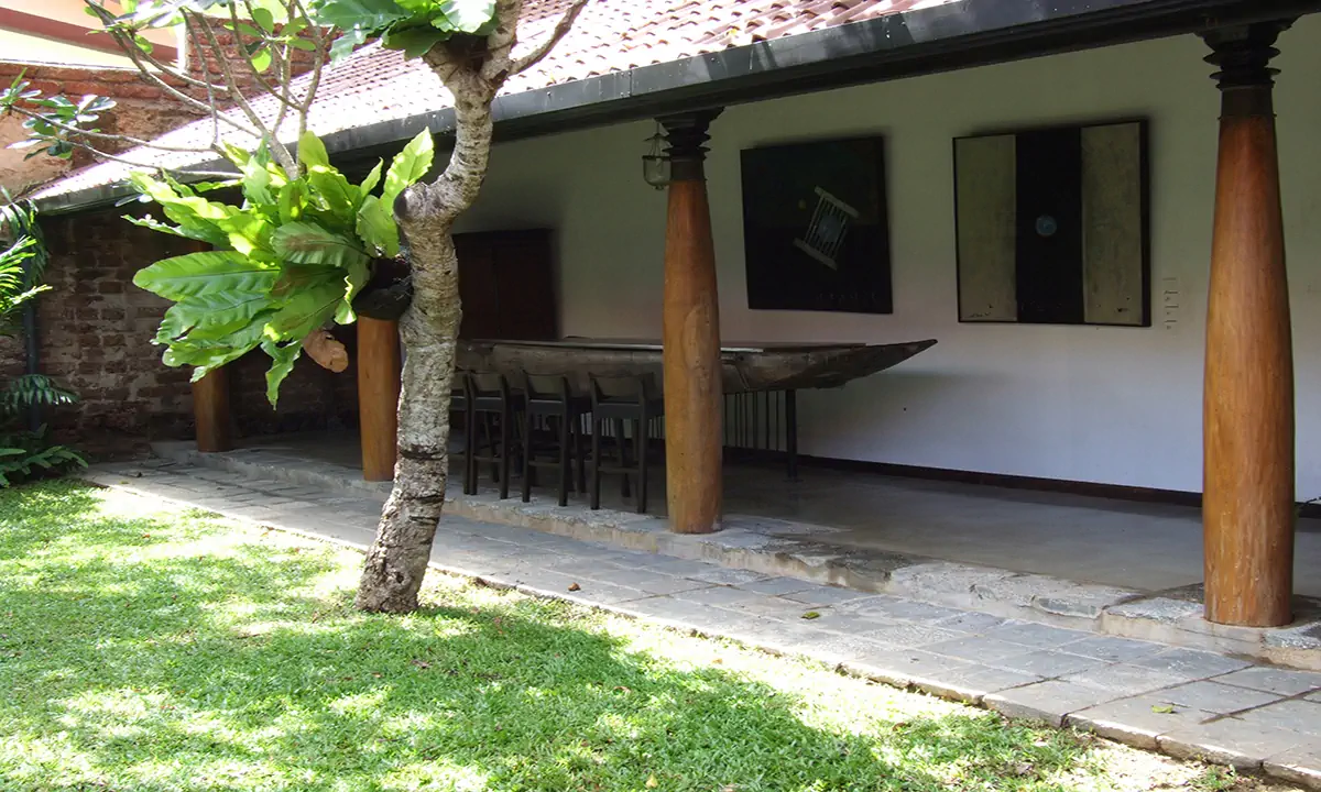 Garden verandah with turned timber columns, artworks and a long counter