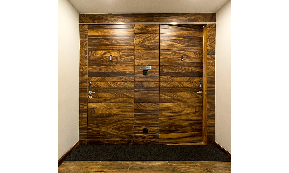 Timber-veneered double doors in a white wall