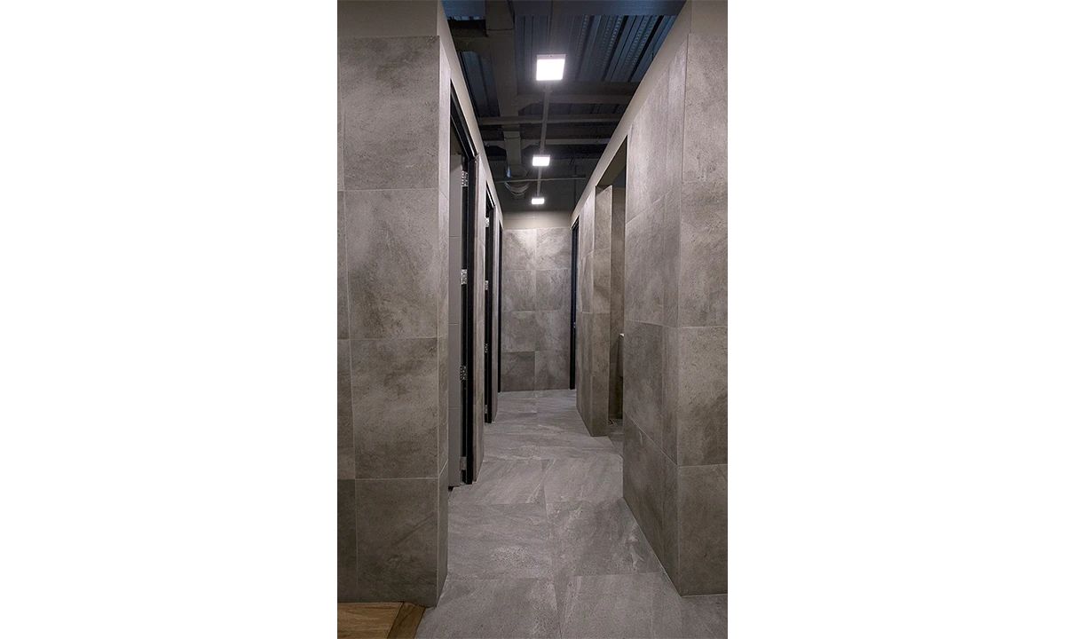 Stone-tiled corridor under a dark ceiling