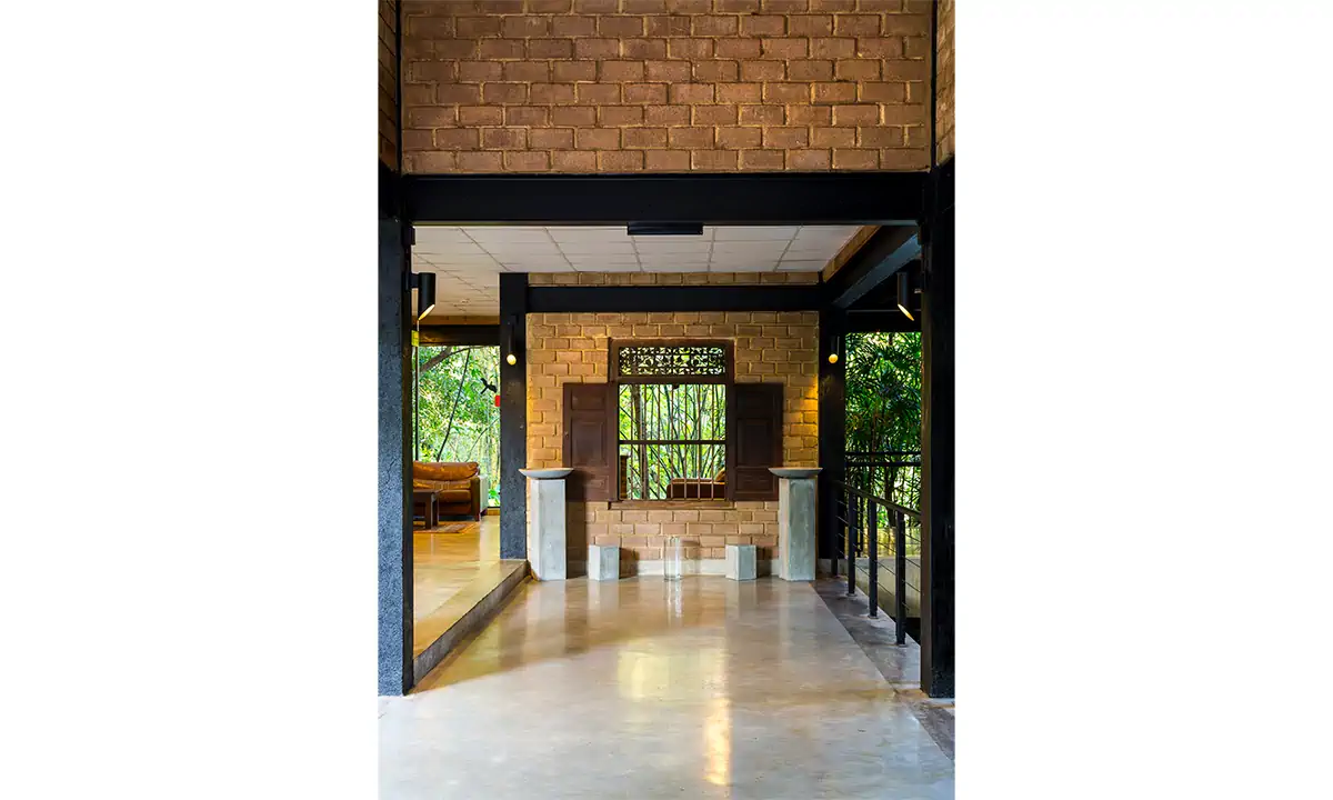 Eco-brick entrance hall framing a timber window