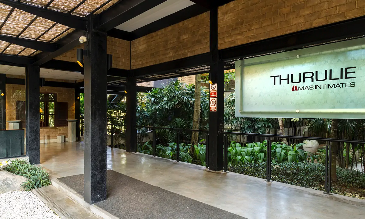 Entrance verandah with the Thurulie MAS Intimates sign, eco-brick walls and planting