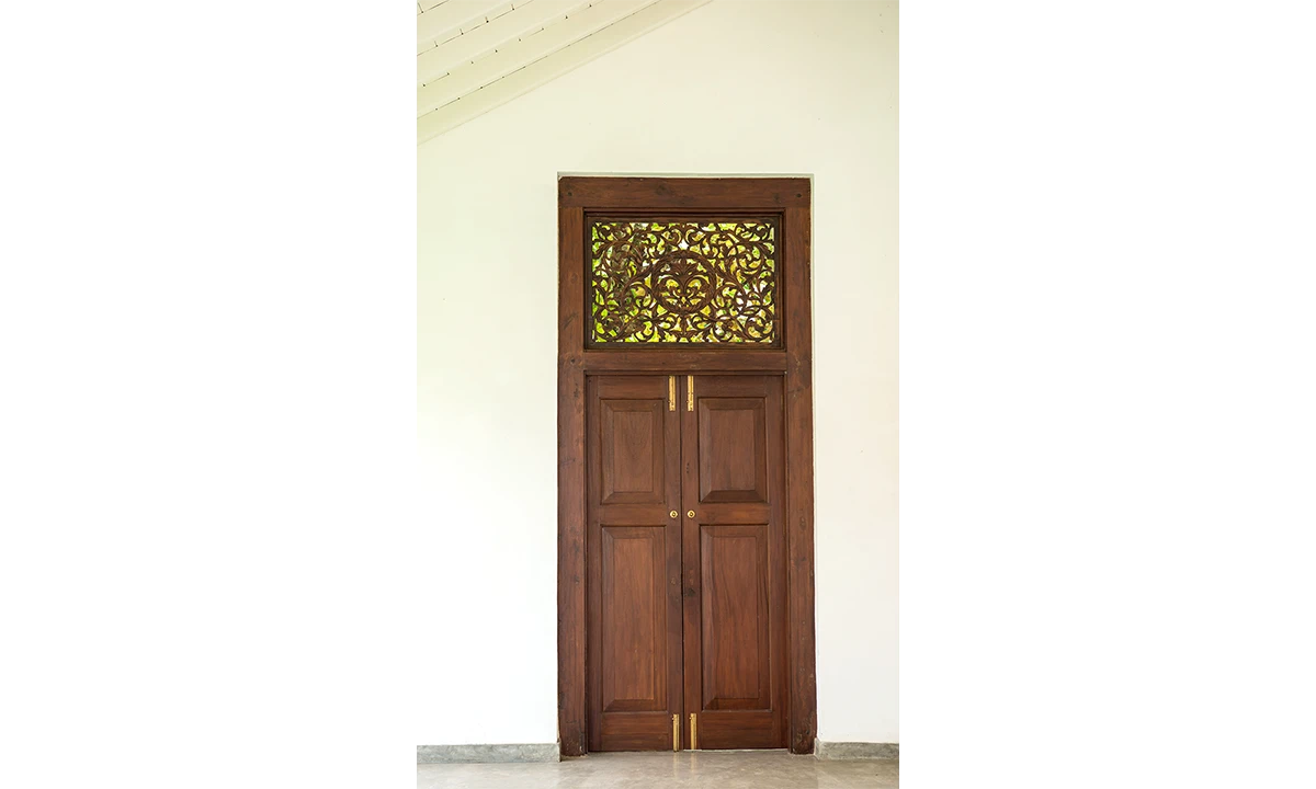 Timber double door with a carved fanlight