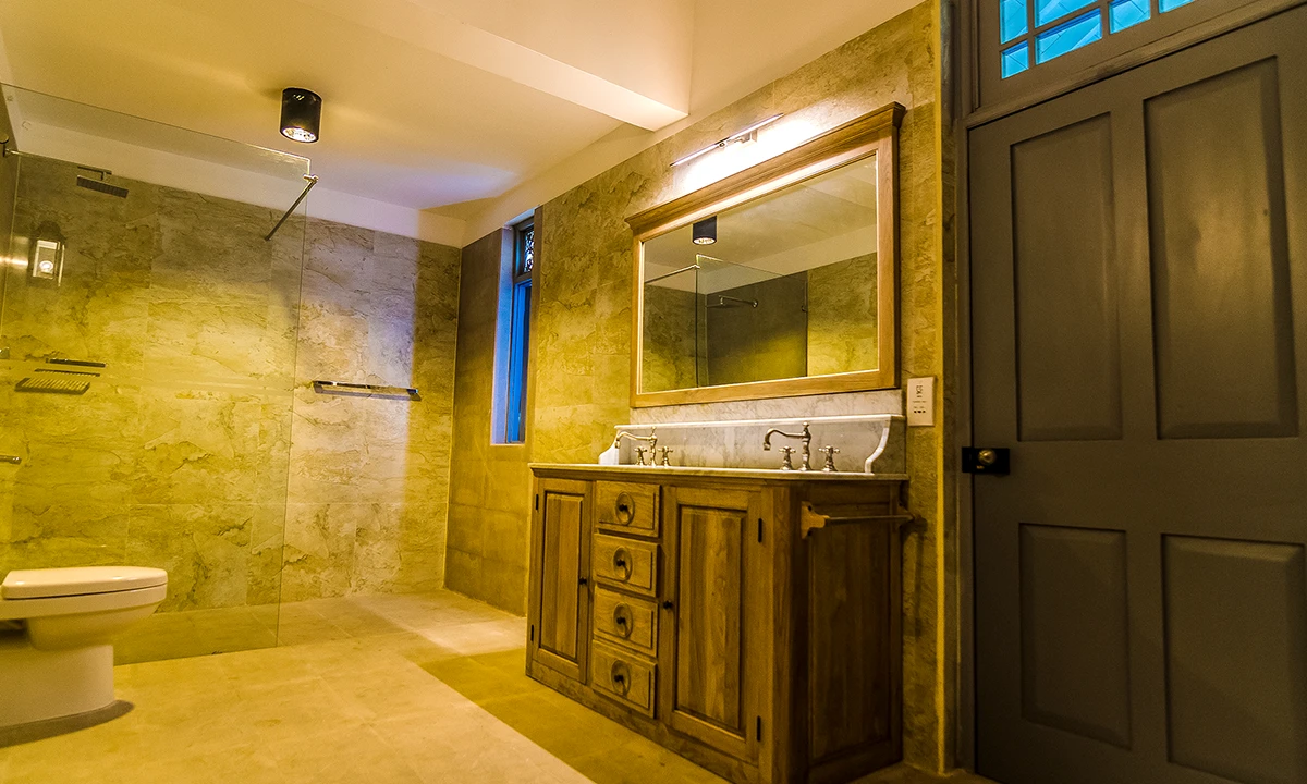 Bathroom with a timber vanity, stone-look tiles and a glass shower