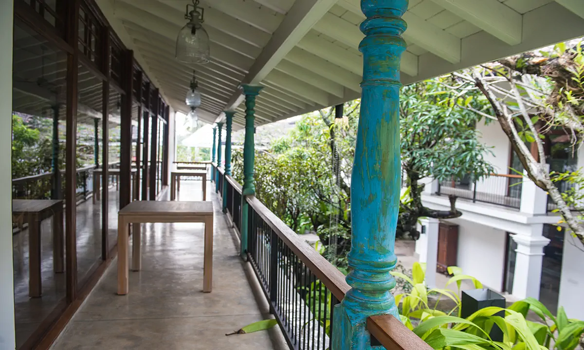 First-floor verandah with a turquoise timber column, overlooking the garden