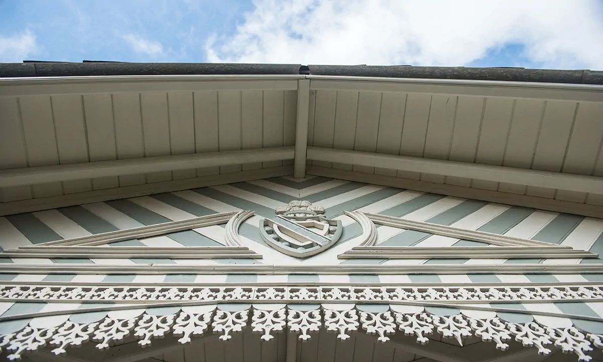 Painted eaves with a crest and carved timber fretwork