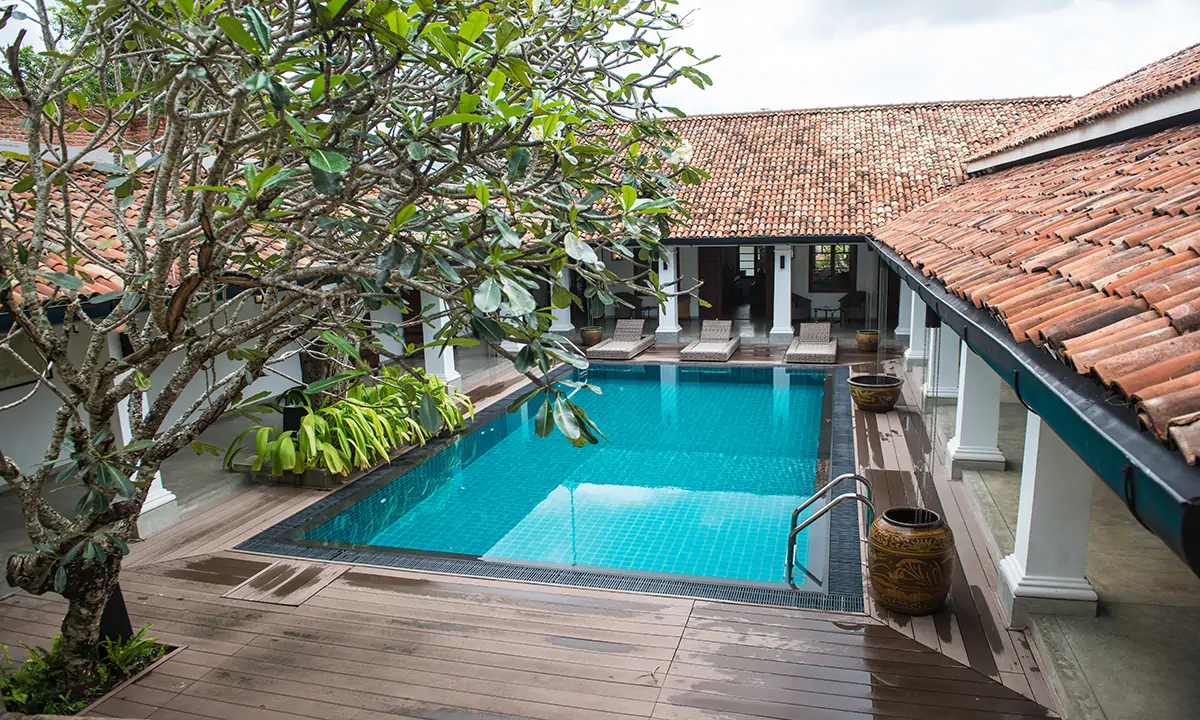 The pool courtyard from above, with a tree and clay-tiled roofs
