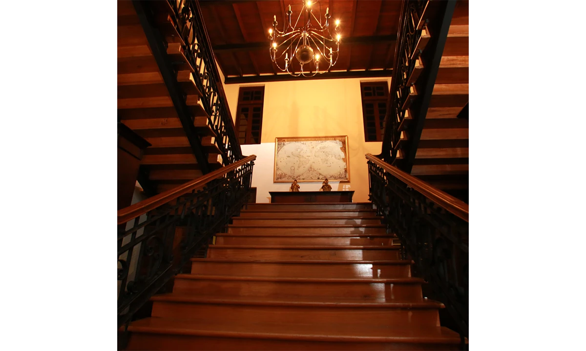Timber staircase under a chandelier